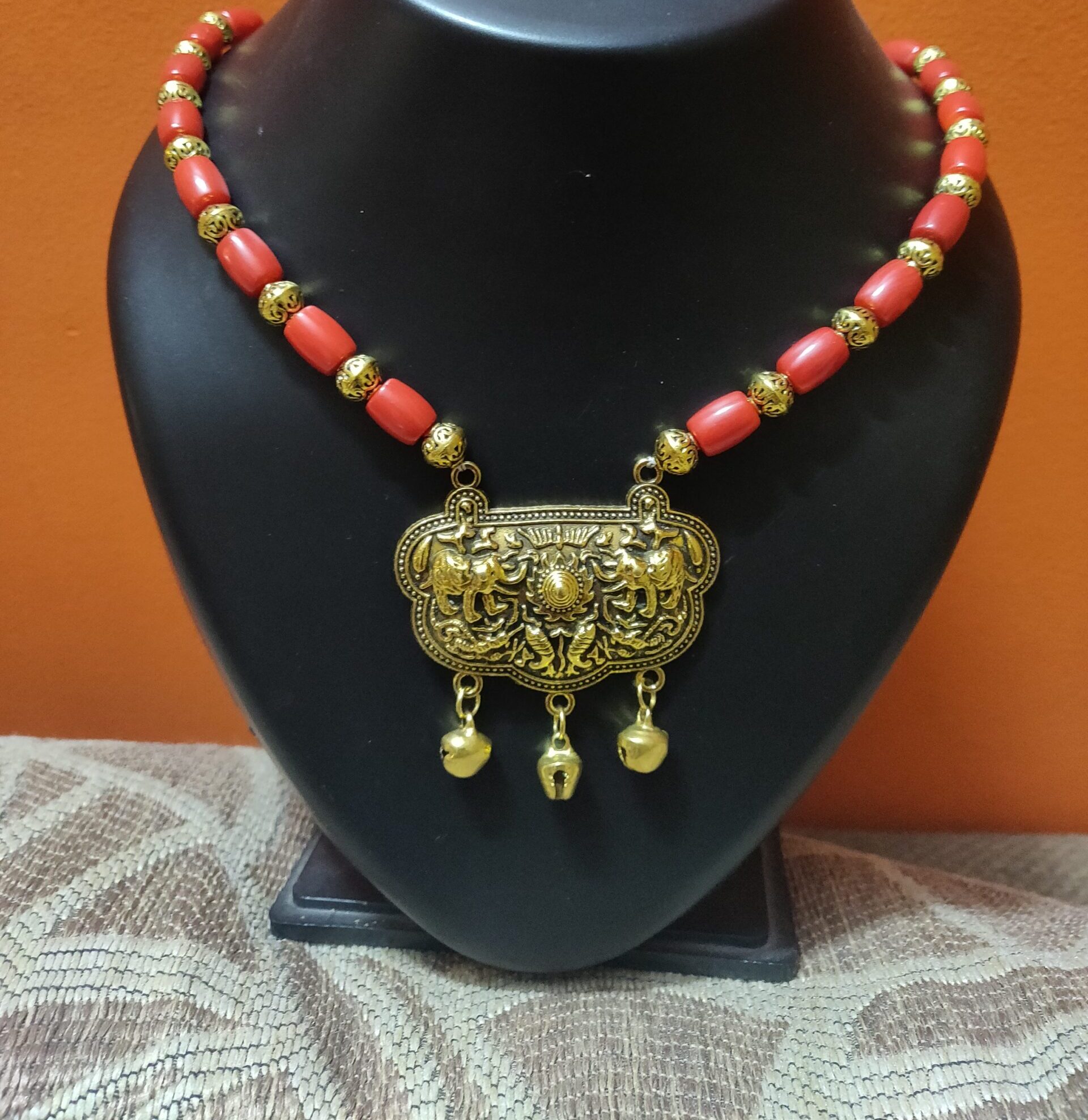 Coral and brass beads necklace with gold plated locket