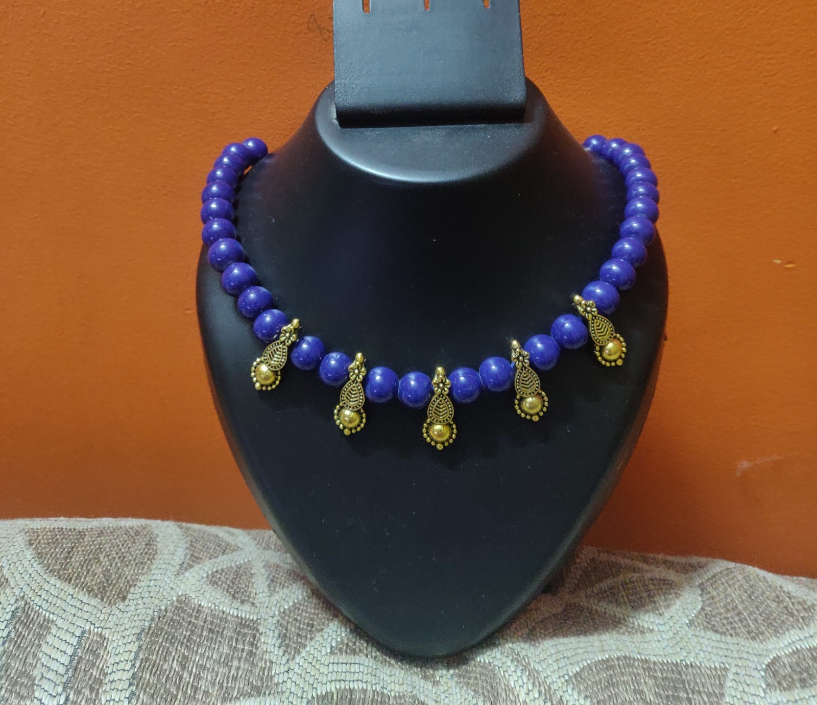 Glass beads in blue with gold charms necklace
