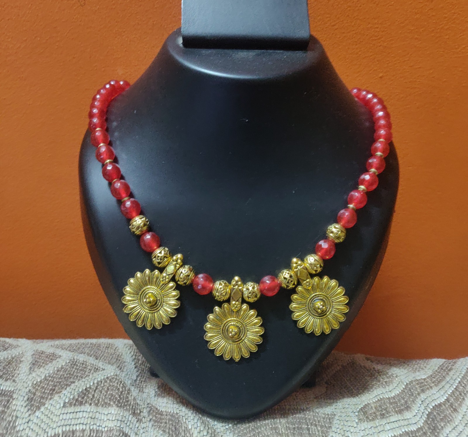 Semi precious beads in red colour with gold charms necklace