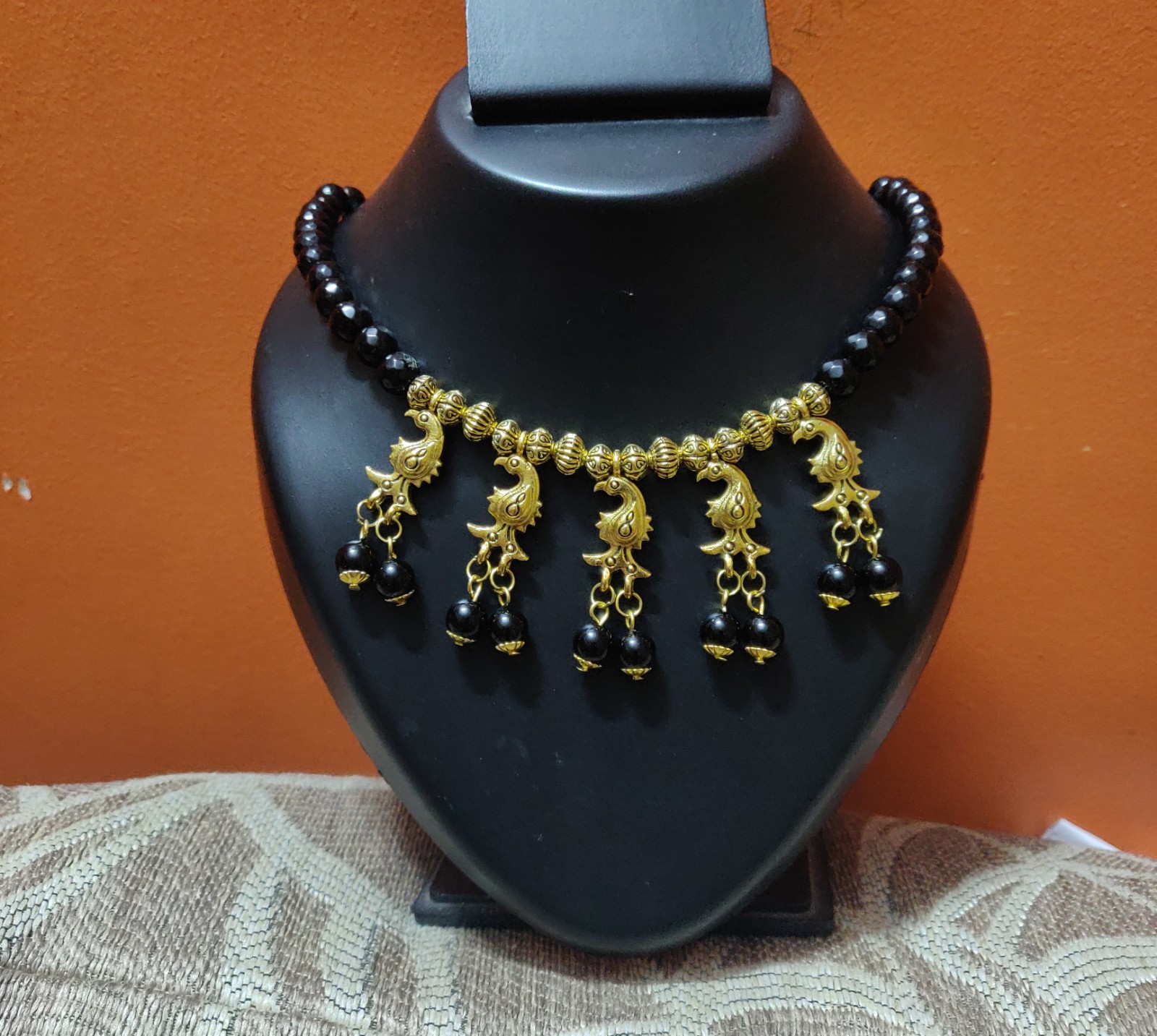 Necklace with Black beads and brass charms
