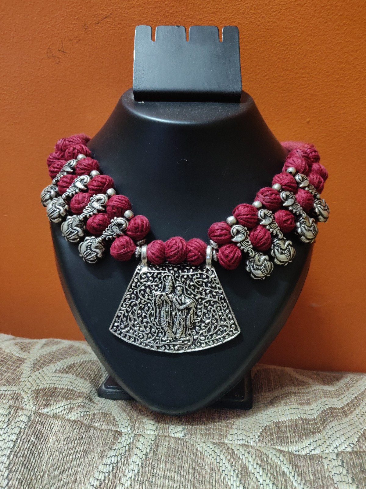 Cotton balls and Radha Krishna pendant necklace with peacock charms.