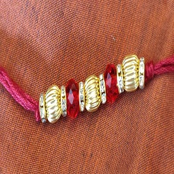 Crystals and gold plated beads rakhi
