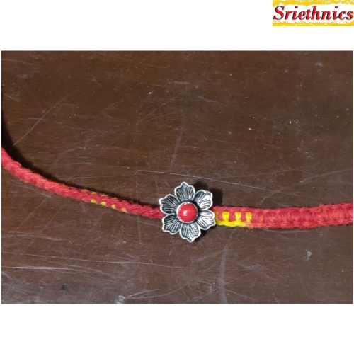 Silver flower with coral rakhi