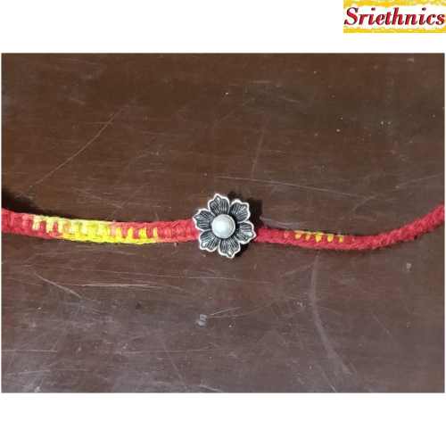 Silver flower with pearl rakhi