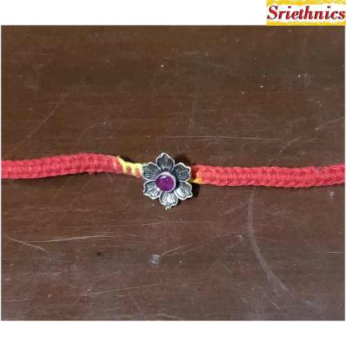 Silver flower with pink stone rakhi