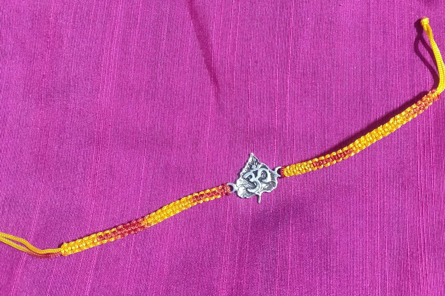 Pure silver OM on leaf Rakhi
